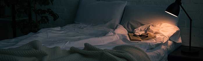 Sleep Wellness: Mastering the art of more restful sleep - image of bed at night